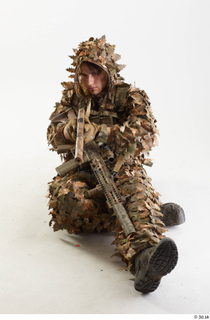 Frankie Perry in Ghillie Sitting aiming gun sitting whole body…